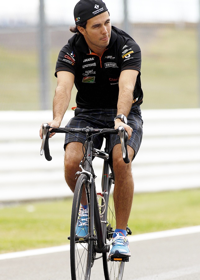 Sergio Perez of Mexico and Force India rides his bike