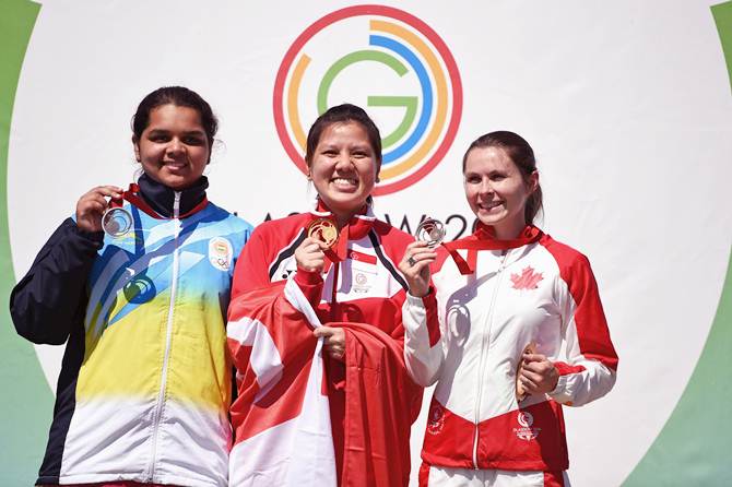 Shun Xie Tao of Singapore (centre), India's Malaika Goel (left) and Dorothy Ludwig of Canada display their medals after the women's 10 metre air pistol event at the Barry Buddon Shooting Centre on Day 2 if the Glasgow 2014 Commonwealth Games