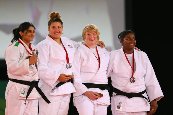 Bronze Rajwinder Kaur of India, Silver medalist Jodie Myers of England, Gold medalist Sarah Adlington of Scotland and bronze medalist Annabelle Laprovidence of Mauritius the podium during the medal ceremony 