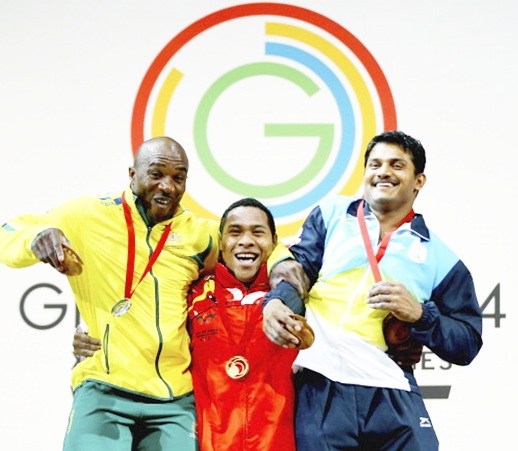 From left, Silver Medalist Simplice Ribouem of Australia, Gold Medalist Steven Kukuna Kari of Papua New Guinea and Bronze Medalist Chandrakant Dadu Mali of India celebrates on the podium
