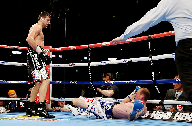 George Groves is kncoked down by Carl Froch in their IBF and WBA World Super Middleweight bout at Wembley Stadium in London on Saturday