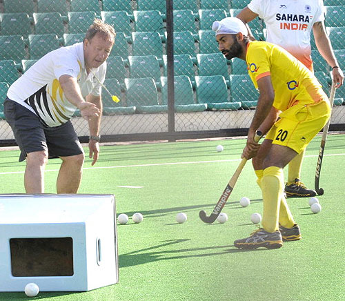 Indian Hockey team coach Terry Walsh giving tips to players during the training session at National Stadium in New Delhi
