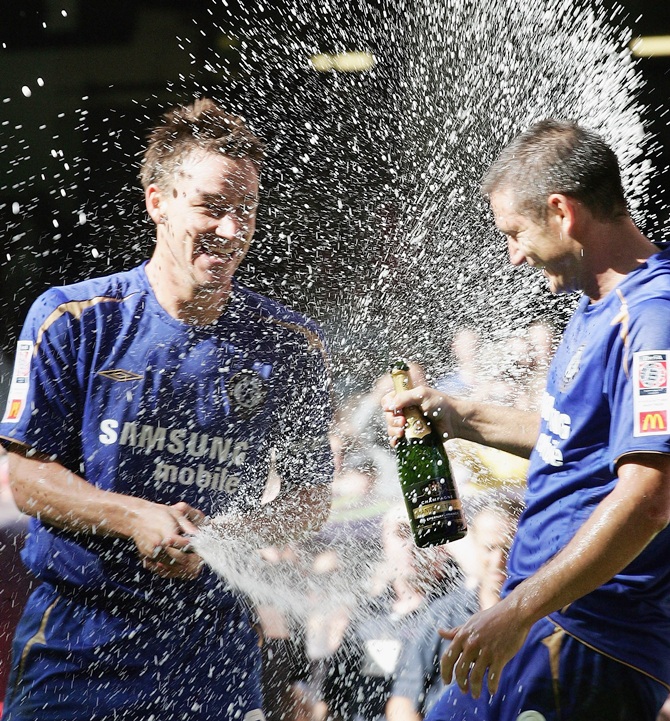 John Terry and Frank Lampard of Chelsea celebrate with champange after winning   the FA Community Shield match against Arsenal and Chelsea at The Millennium Stadium on August 7, 2005 in Cardiff