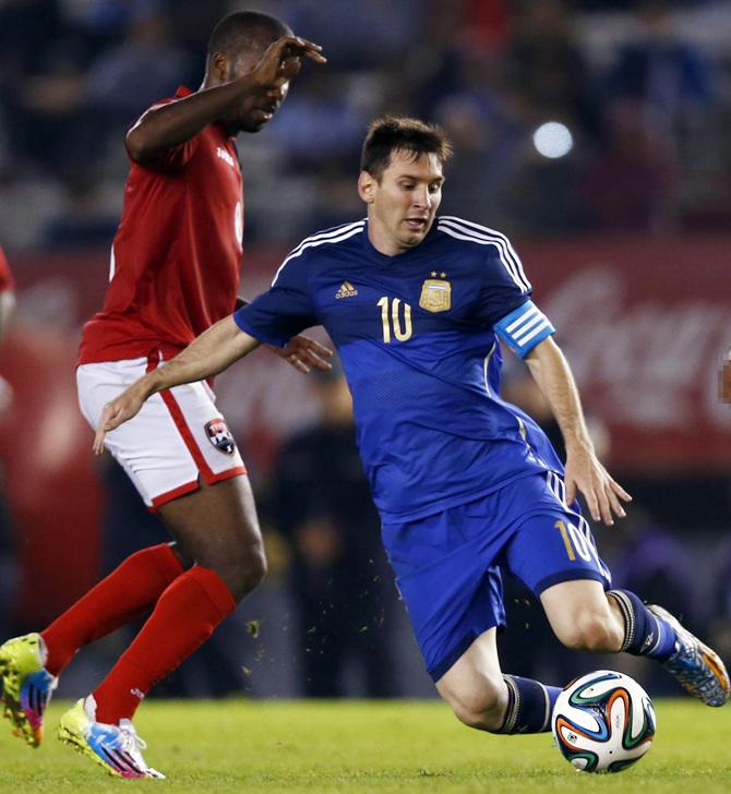 Argentina's Lionel Messi (right) is challenged by Trinidad and Tobago's Khaleem Hyland.