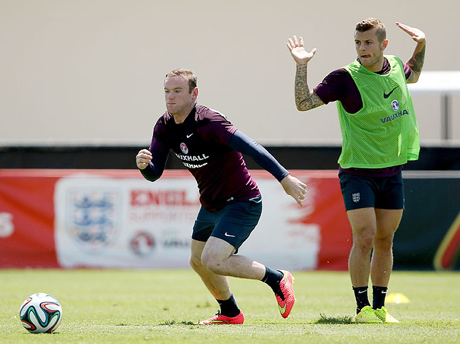 Wayne Rooney (left) and Jack Wilshire go through the grind during an England training session at the Barry University Campus