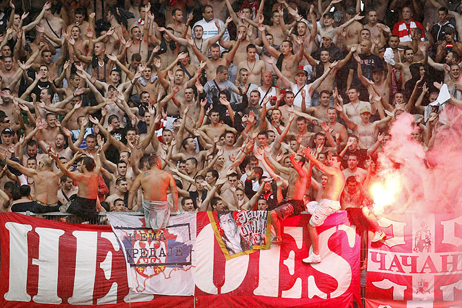 Red Star Belgrade's fans light flares in the stand