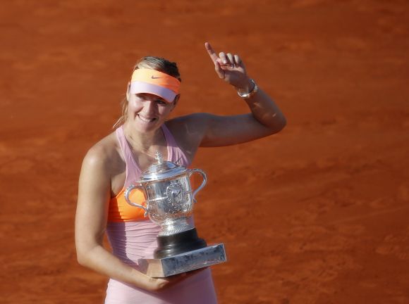 Maria Sharapova of Russia poses with the trophy during the ceremony after defeating Simona Halep of Romania 