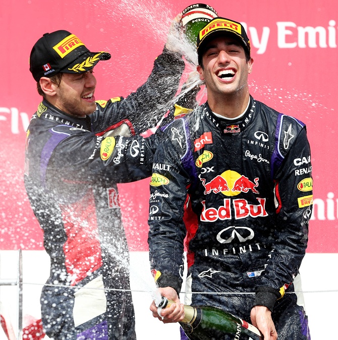 Racewinner Daniel Ricciardo of Australia and Infiniti Red Bull Racing is   sprayed with champagne by teammate Sebastian Vettel of Germany
