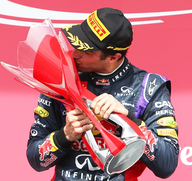 Racewinner Daniel Ricciardo of Australia and Infiniti Red Bull Racing kisses the trophy