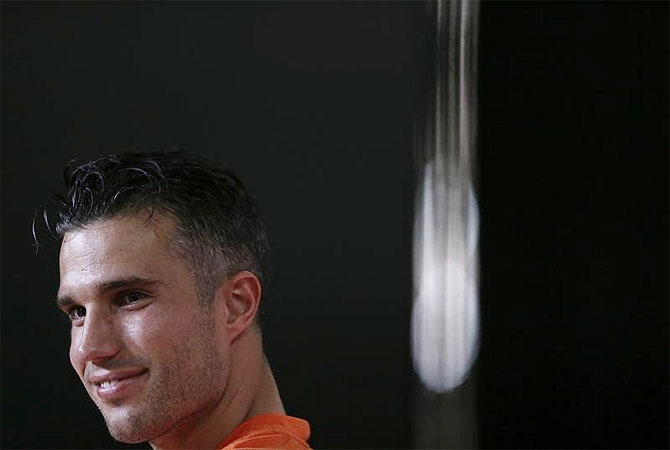 Netherlands' national soccer team player Robin Van Persie attends a news conference after a training session ahead of the 2014 World Cup in Rio de Janeiro on Sunday