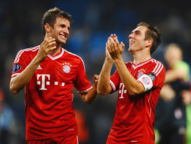 Thomas Muller and Philipp Lahm of FC Bayern Muenchen celebrate