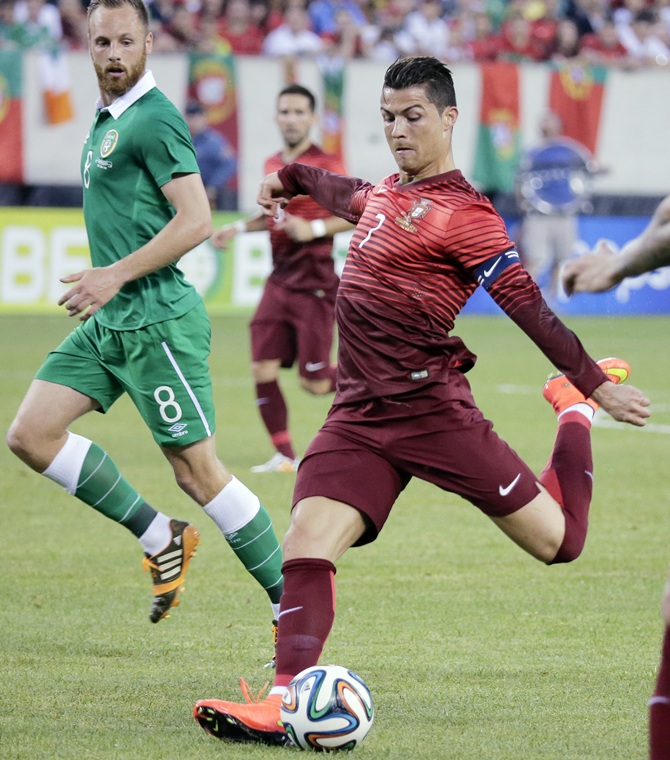 Portugal's Cristiano Ronaldo tries a shot past Ireland's David Meyler