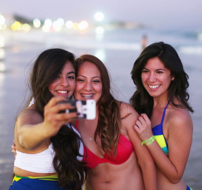 Girls take a selfie photo on Ipanema beach in Rio de Janeiro, Brazil