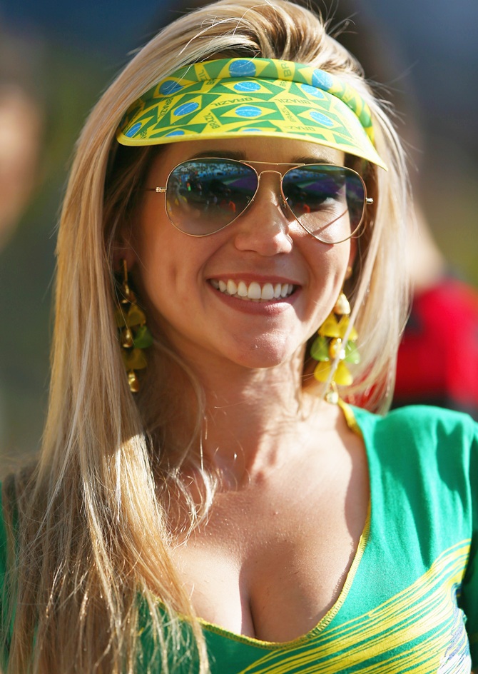 A Brazil fan poses before the Opening Ceremony