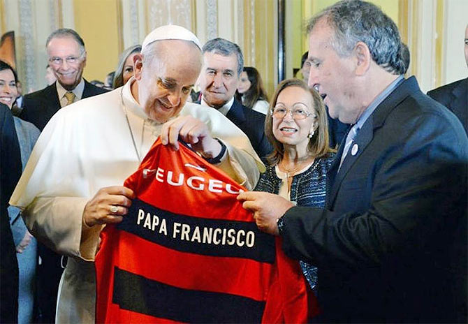 Pope Francis receives a jersey on the eve of the commencement of the FIFA World Cup 