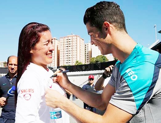 Cristiano Ronaldo signs a fan's shirt before Portugal's practice session on Thursday