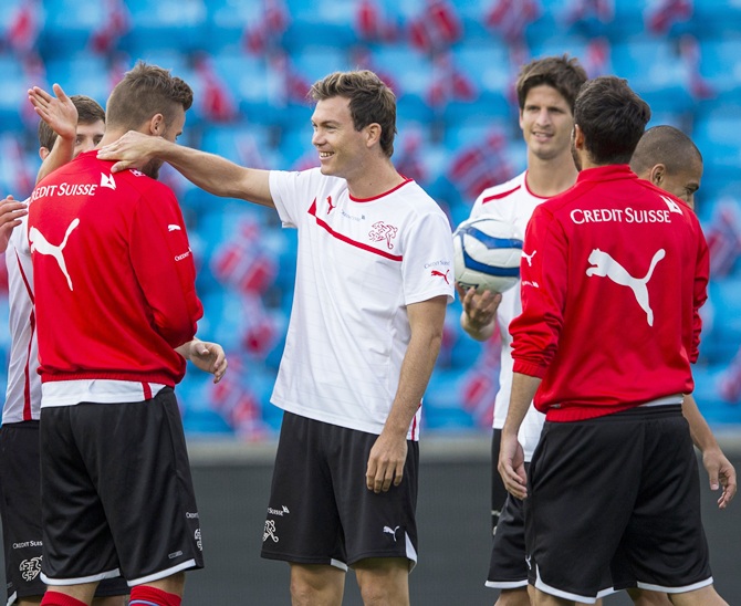 Swiss national soccer team player Stephan Lichtsteiner, centre, attends a training session