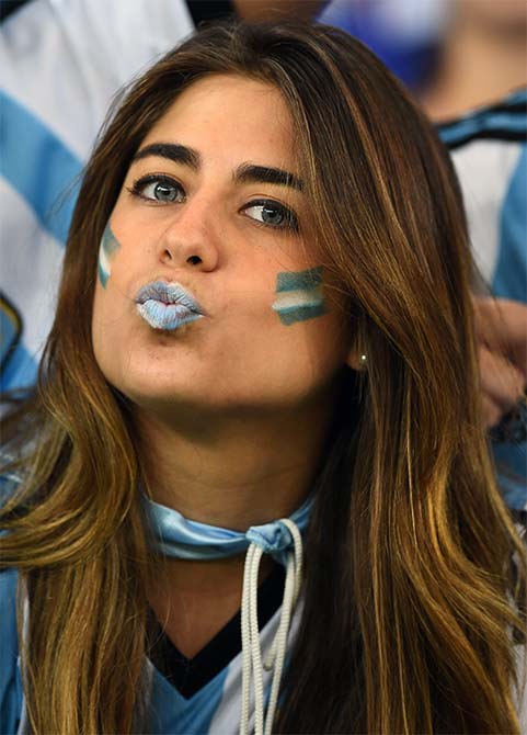 An Argentina fan blows a kiss