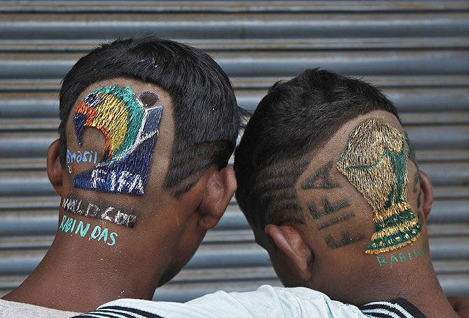 Indian soccer fans pose after getting fancy hairdos