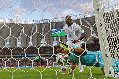 Goalkeeper Noel Valladares of Honduras tries to prevent the ball from crossing the goalline following a shot by France's Karim Benzema.Ka