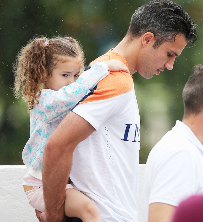 Robin van Persie holds his daughter, Dina Layla van Persie during the Netherlands training session
