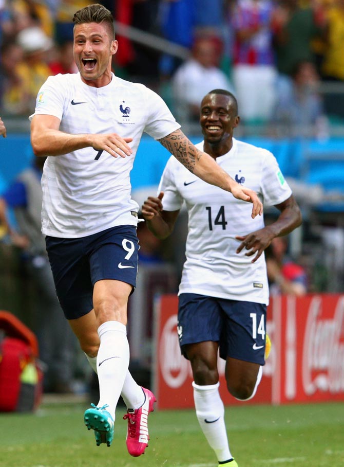 Olivier Giroud of France (left) celebrates scoring his team's first goal 