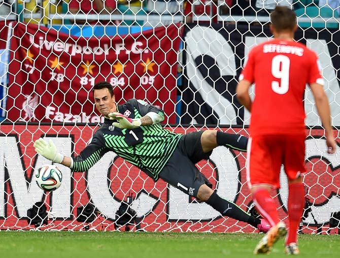 Switzerland goalkeeper Diego Benaglio saves the penalty from Karim Benzema