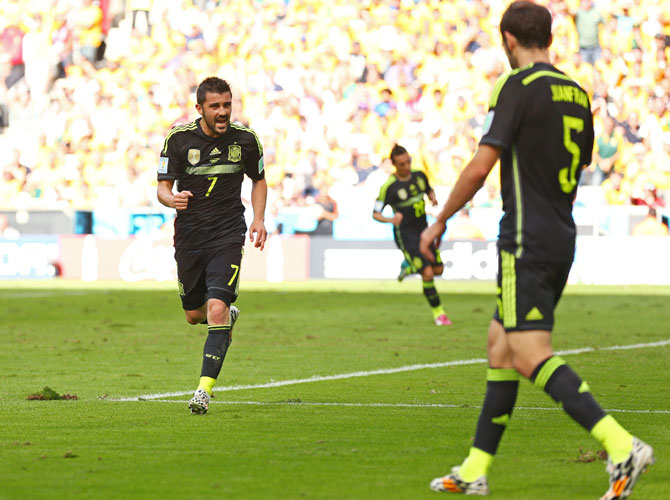 David Villa of Spain (left) celebrates scoring his team's first goal with Juanfran