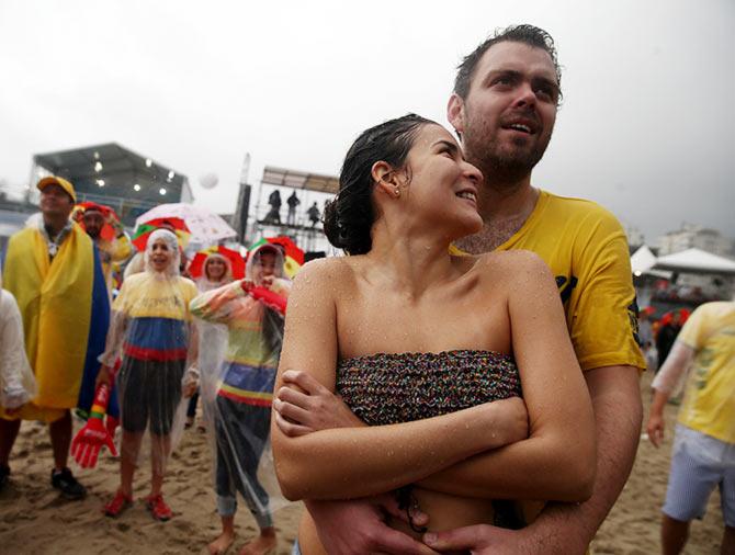 Colombian soccer team fans watch their game against Ivory Coast at the Word Cup FIFA Fan Fest on Copacabana beach in Rio de Janeiro.