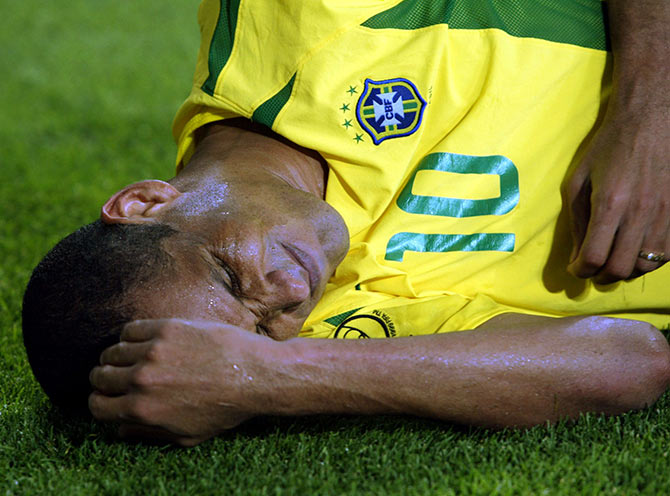 Brazilian midfielder Rivaldo lies near the corner flag