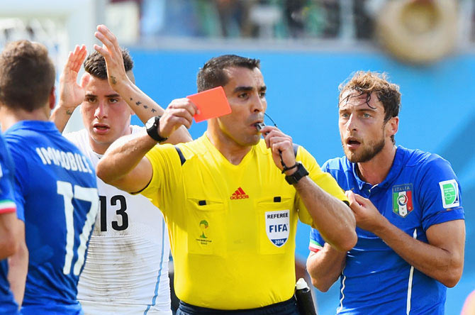Referee Marco Rodriguez shows a red card to Claudio Marchisio of Italy
