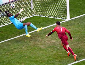 Ghana goalkeeper Fatawu Dauda makes a save off a header at goal by Cristiano Ronaldo of Portugal