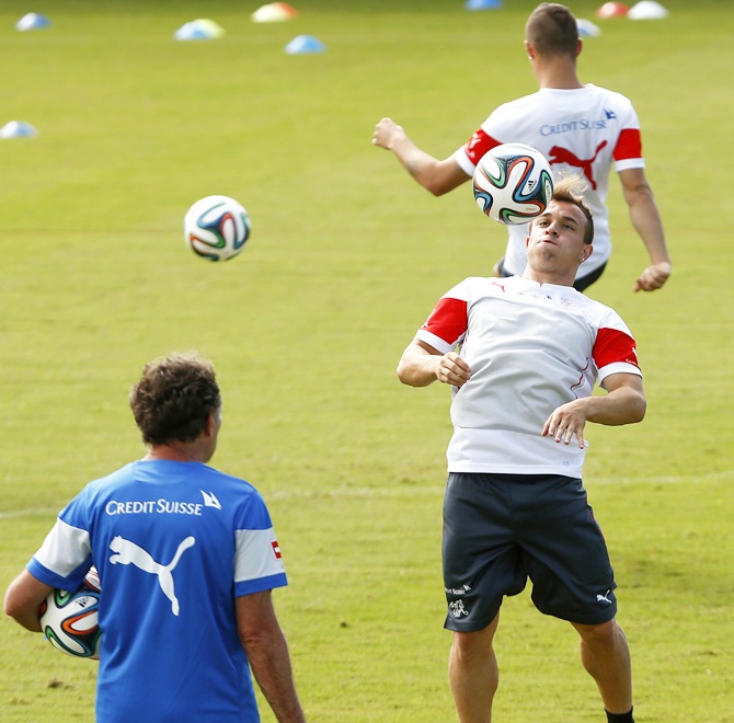 Switzerland's national soccer team player Xherdan Shaqiri, centre, controls the ball during a World Cup 2014 training session at the stadium in Porto Seguro