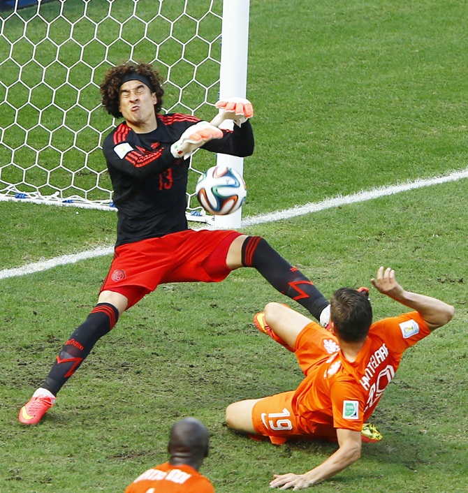 Mexico's goalkeeper Guillermo Ochoa saves a goal shot by Klaas-Jan Huntelaar of the Netherlands