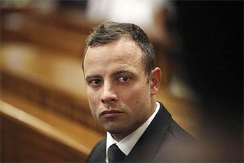 Olympic and Paralympic track star Oscar Pistorius sits in the dock on the third day of his trial for the murder of his girlfriend Reeva Steenkamp at the North Gauteng High Court in Pretoria, on Wednesday
