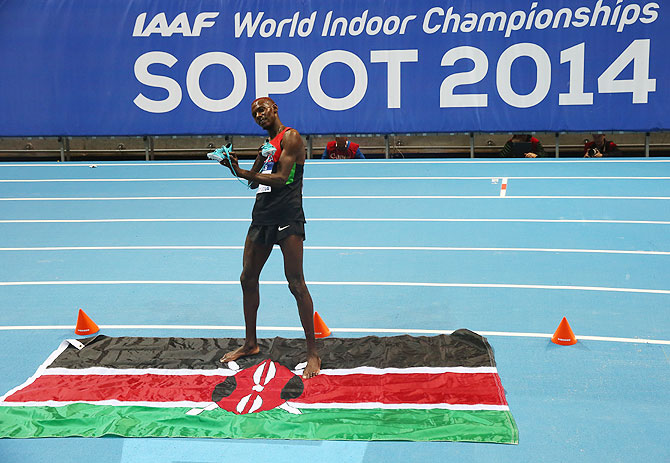 Caleb Mwangangi Ndiku of Kenya shows of his shoes as he celebrates winning gold in the Men's 3000m Final on Day 3 of the IAAF World Indoor Championships on Sunday