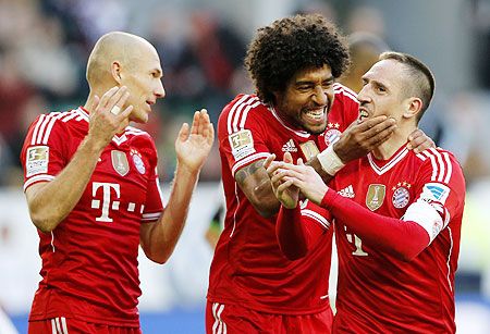 Bayern's Franck Ribery of France (right) celebrates with teammates Arjen Robben (left) and Dante after scoring against Wolfsburg during their German Bundesliga match in Wolfsburg, on Saturday