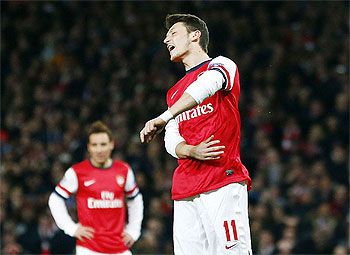 Arsenal's Mesut Ozil reacts after missing a penalty against Bayern Munich during their Champions League match last month