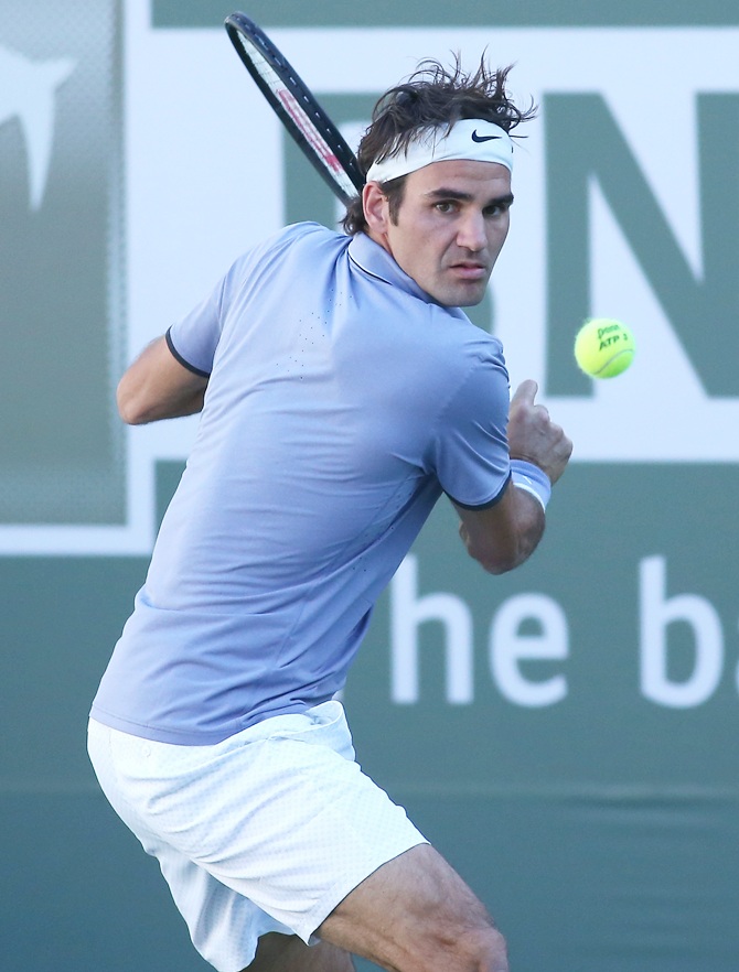 Roger Federer of Switzerland hits a return