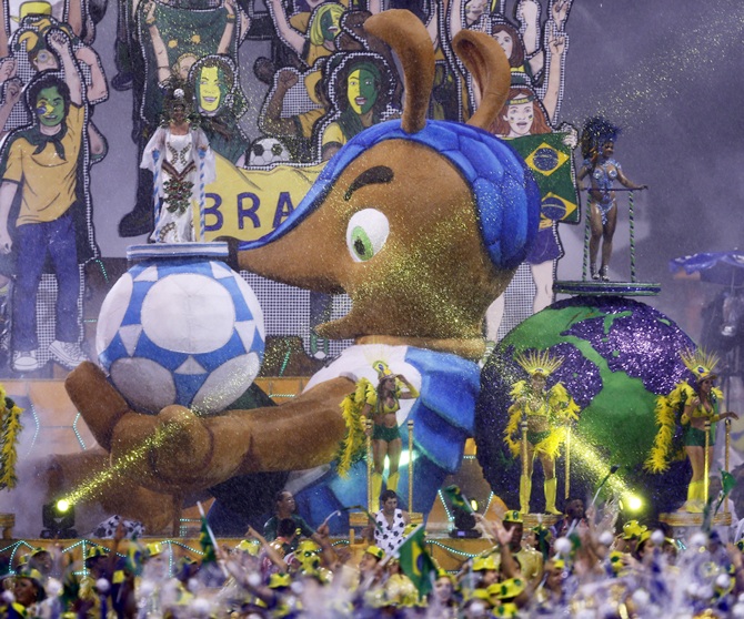 The official mascot of the FIFA 2014 World Cup, Fuleco the Armadillo, is seen on a float