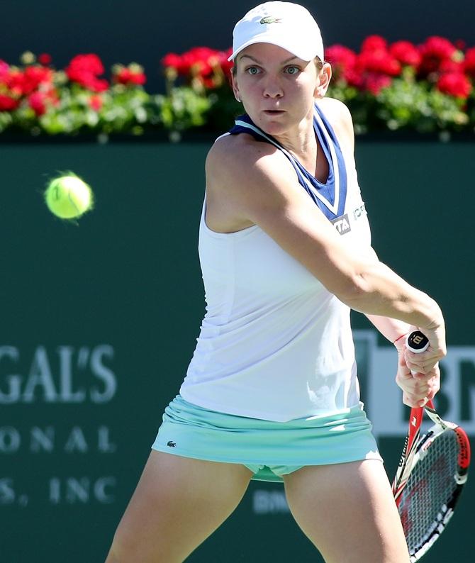 Simona Halep of Romania hits a return