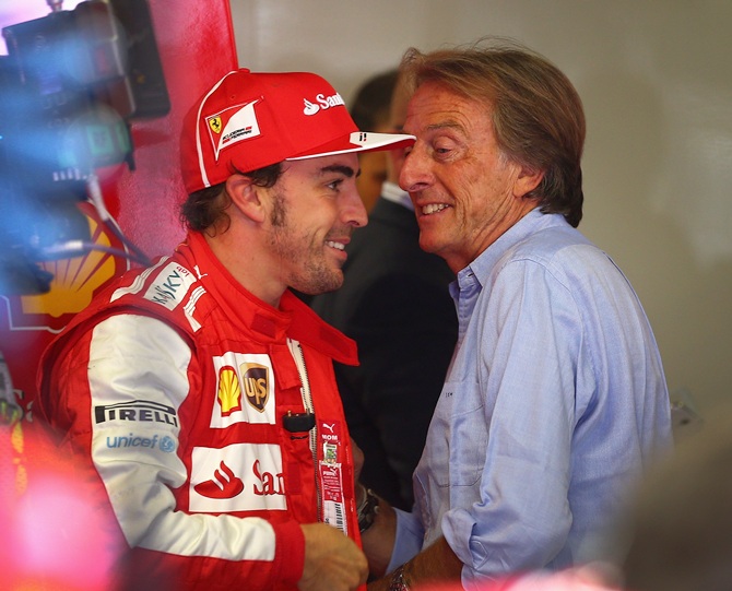 Ferrari Chairman Luca Cordero di Montezemolo, right, talks with Fernando Alonso