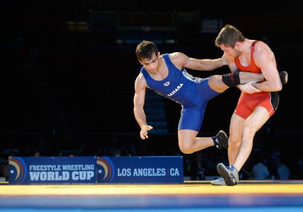 Andrew Hochstrasser of the United States picks Amit Kumar of India off the mat during the 2014 FILA Freestyle Wrestling World Cup at The Forum in Inglewood, California