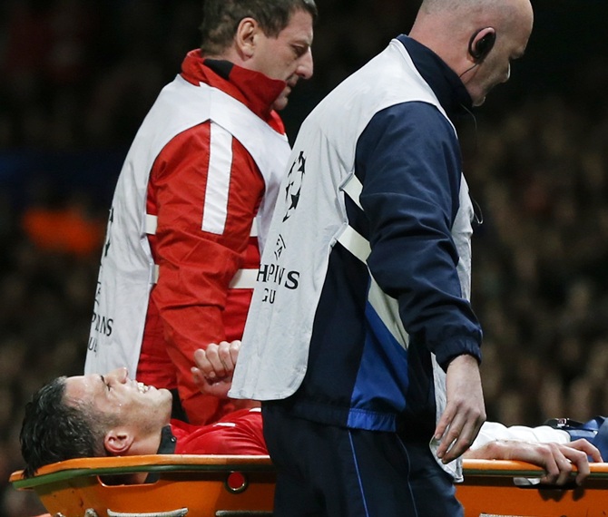 Manchester United's Robin van Persie leaves the pitch on a stretcher