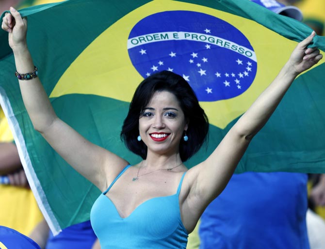 Brazilian football fan cheers for her team.