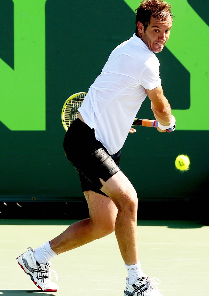 Richard Gasquet of France returns a shot to Kevin Anderson of South Africa