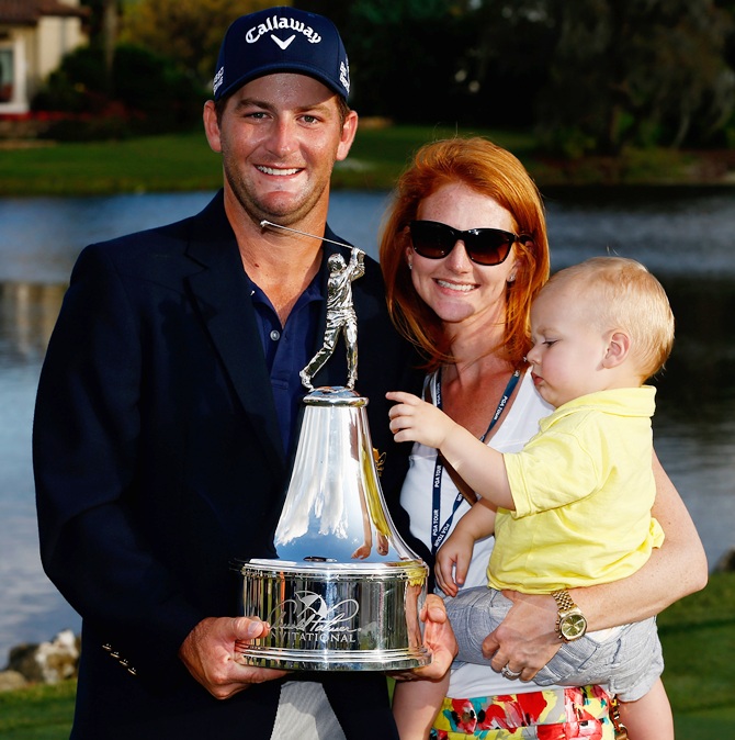 Matt Every of the United States holds the trophy as he celebrates   with his wife Danielle and son Liam after winning the Arnold Palmer Invitational