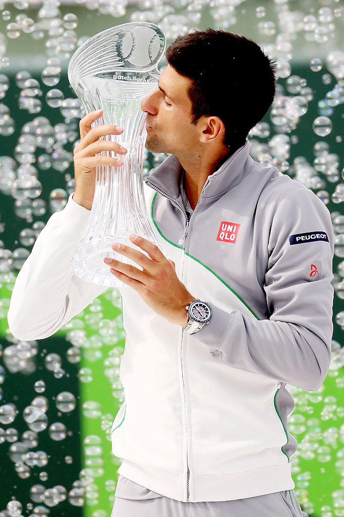 Novak Djokovic of Serbia poses for photographers with the Butch Buchholz Torphy after defeating Rafael Nadal of Spain to win the Miami Masters Sony Open final at the Crandon Park Tennis Center in Key Biscayne, Florida on Sunday