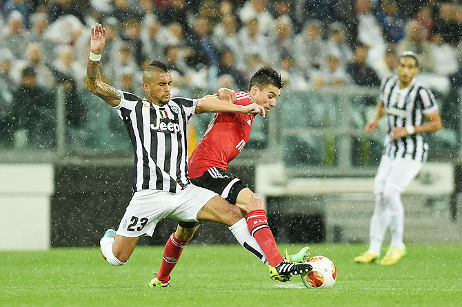 Arturo Vidal (left) of Juventus tackles Andre Gomes of Benfica during their Europa League semi-final on Thursday