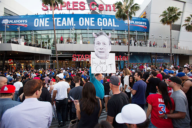 A photo cutout of Los Angeles Clippers owner Donald Sterling is seen among people standing in line for the NBA playoff game 5 between Golden State Warriors and Los Angeles Clippers at Staples Center in Los Angeles, California on Tuesday